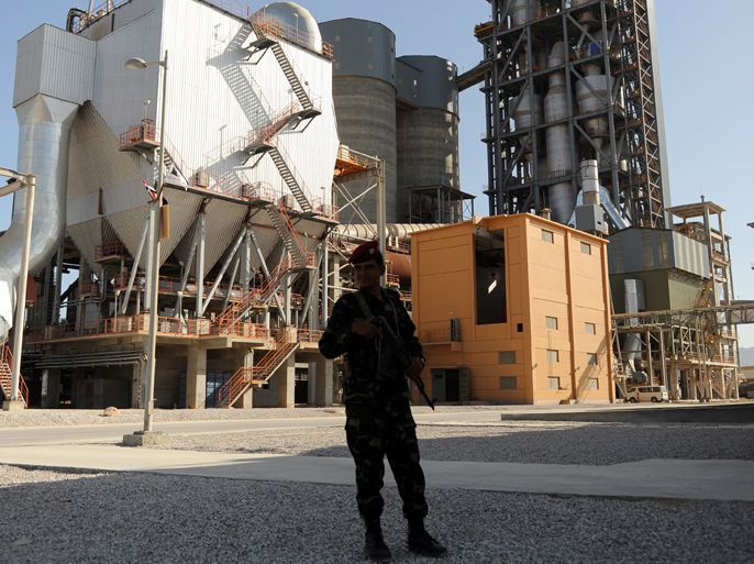 epa02107637 A Yemeni soldier stands guard at a US$ 260 million cement factory of Saudi businessmen in the province of Hadramout, eastern Yemen, on 07 April 2010. Saudi investors opened a cement factory in the eastern part of Yemen as international donors, including Saudi Arabia, seek to help Yemen overcome its economic, developmental and security problems as well as the threat of al-Qaeda in the Arabian Peninsula. EPA/YAHYA ARHAB