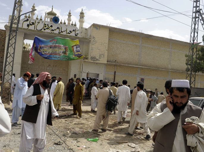 Pakistani Sunni Muslims gather outside the Sunni Muslim seminary after a bomb explosion at the seminary on the outskirts of Quetta on June 7, 2012. A bomb attack killed at least eight people and wounded more than 20 others outside a Pakistani madrassa in the troubled southwestern city of Quetta, police said. The bomb was detonated outside the gates of the Sunni Muslim seminary as a ceremony awarding degrees to students was being held inside. AFP PHOTO
