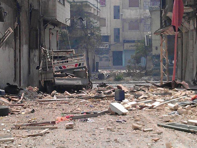 آثار الدمار جراء القصف على حي جورة الشياح بحمص (الفرنسية)