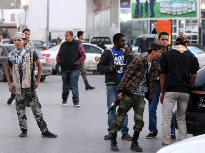 Libyan militia members man a checkpoint in the capital Tripoli on December 6, 2011. Libya's government gave its firm support to a two-week deadline for militias that led the uprising which toppled Moamer Kadhafi to quit Tripoli, backing up a threat from the capital's council to lock down the city if they fail to do so.