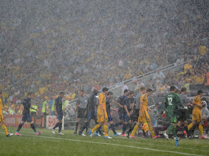 DONETSK, UKRAINE - JUNE 15: Players leave the pitch after play was suspended to due to weather during the UEFA EURO 2012 group D match between Ukraine and France at Donbass Arena on June 15, 2012 in Donetsk, Ukraine. (Photo by Lars Baron/Getty Images)