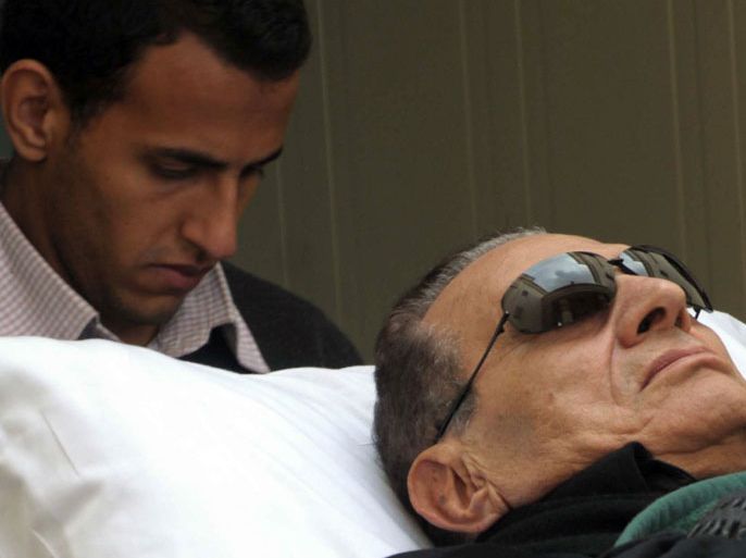 EGYPT (FILES) -- A file picture taken on January 5, 2012 shows Egypt's ousted president Hosni Mubarak being wheeled on a stretcher into a court for his trial in Cairo on January 5, 2012.