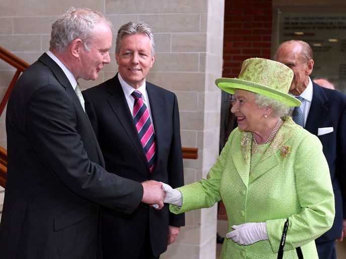AA537 - BELFAST, Northern Ireland, UNITED KINGDOM : Britain's Queen Elizabeth II (2nd R) shakes hands with Northern Ireland Deputy First Minister Martin McGuinness (L) watched by First Minister Peter Robinson (2nd L) at the Lyric Theatre in Belfast, Northern Ireland, on June 27, 2012