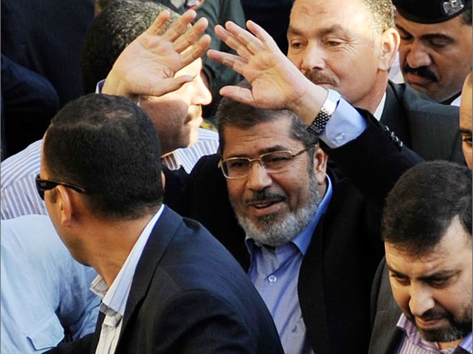 Egypt's Islamist President-elect Mohamed Mursi waves to his supporters after his speech in Cairo's Tahrir Square June 29, 2012. Mursi took an informal oath of office on Friday before tens of thousands of supporters in Cairo's Tahrir Square, in a slap at the generals trying to limit his power. REUTERS/Egyptian Presidency/Handout (EGYPT - Tags: POLITICS) FOR EDITORIAL USE ONLY. NOT FOR SALE FOR MARKETING OR ADVERTISING CAMPAIGNS. THIS IMAGE HAS BEEN SUPPLIED BY A THIRD PARTY. IT IS DISTRIBUTED, EXACTLY AS RECEIVED BY REUTERS, AS A SERVICE TO CLIENTS