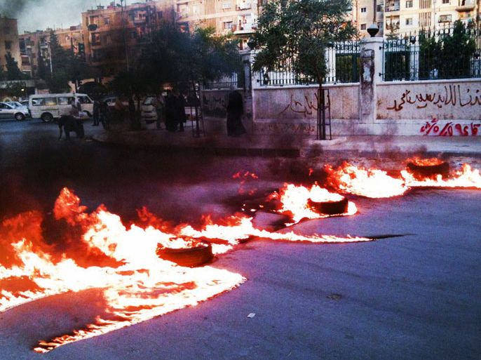 handout image released by the Syrian opposition's Shaam News Network allegedly shows a road blocked with burning tyres in Al-Midan district of the Syrian capital Damascus on June 17, 2012. Syria's opposition issued a cry for help as regime forces pounded rebel bastions in Homs province and activists warned that hundreds of civilians were trapped with little food or water. AFP PHOTO