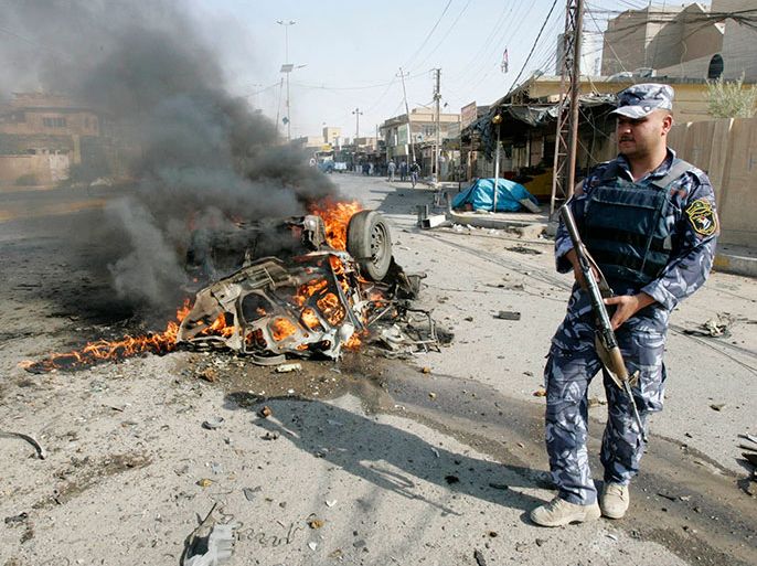 A policeman stands guard at the site of a bomb attack in Kirkuk, 250km (155 miles) north of Baghdad July 23, 2012. The death toll in a string of bomb attacks in Iraq on Monday rose to 39, with at least 118 wounded, police and hospital sources said. The explosions included a car bomb and a suicide attack, in and around the Iraqi capital Baghdad, as well as four car bombs in the northern oil city of Kirkuk. REUTERS