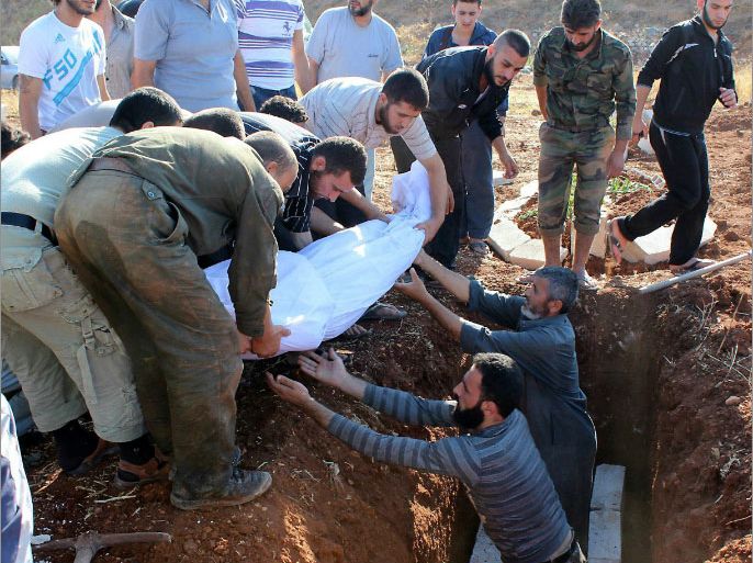 A handout picture released by the Syrian opposition's Shaam News Network on July 15, 2012 shows Syrian mourners burying the body of a man identified as Issa al-Anjari during his funeral in Baba Amr in the flashpoint city of Homs on July 14, 2012. Iran, the main regional ally of Syria, said on July 15 it is ready to host a meeting between Damascus and its opponents aimed at solving the country's conflict. AFP PHOTO/HO/SHAAM NEWS NETWORK