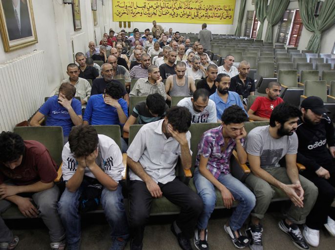 Syrians detainees, who were arrested over participation in the protests against Syrian President Bashar al-Assad's regime, are seen at the Damascus police leadership building July 11, 2012, to sign their release papers. The Syrian government said it had released a total of 275 prisoners, who had not been involved in homicide. REUTERS