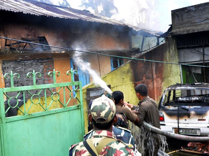 Fire fighters put out a fire in a house which was set alight by rioters at Narabari village in Kokrajhar district, about 230 kms from Guwahati, the capital city of the northeastern state of Assam on July 24, 2012. New clashes took the death toll from ethnic violence in India's remote northeast to 22