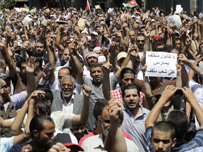 Jordanian protesters, mostly Islamists, chant slogans during a demonstration after the Friday prayers in Amman on July 13, 2012 to reject a controversial electoral law, a day after the Muslim Brotherhood decided to boycott early polls expected later this year. The Brotherhood's shura advisory council voted on July 12 to boycott parliamentary elections because of "lack of political reform." AFP PHOTO/KHALIL MAZRAAWI
