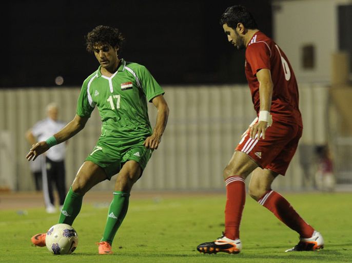 Iraq's player Alaa al-Azawi (L) fights for the ball with Ahmed Jahuh (R) of Tunisia during their 2012 Arab Cup semi-final football match in the port city of Jeddah on July 3, 2012. AFP PHOTO/AMER HILABI