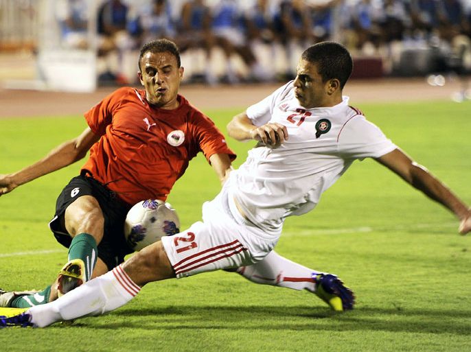 Morocco's Oussama Gharib (R) challenges Libya's Mohammed Ali Snani during their 2012 Arab Cup final football match in the Saudi coastal city of Jeddah on July 6, 2012. AFP PHOTO/AMER HILABI