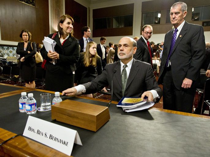 KBS241 - Washington, District of Columbia, UNITED STATES : US Federal Reserve Board Chairman Ben Bernanke packs up after finishing testimony before the Senate Banking, Housing and Urban Affairs Committee ON July 17, 2012 on Capitol Hill in Washington. Bernanke is delivering the semiannual Monetary Policy Report to Congress. AFP PHOTO/Karen BLEIER