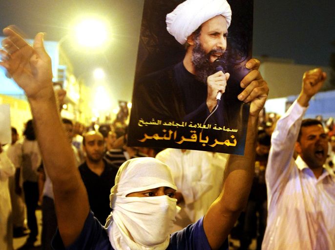 A protester holds up a picture of Sheikh Nimr al-Nimr during a rally at the coastal town of Qatif, against Sheikh Nimr's arrest July 8, 2012. Sheikh Nimr, a prominent Shi'ite Muslim cleric who was wanted by the police, was detained in Saudi Arabia's Eastern Province on Sunday over calls for more rights for the minority Muslim sect in the Sunni monarchy, his brother and an activist said. REUTERS