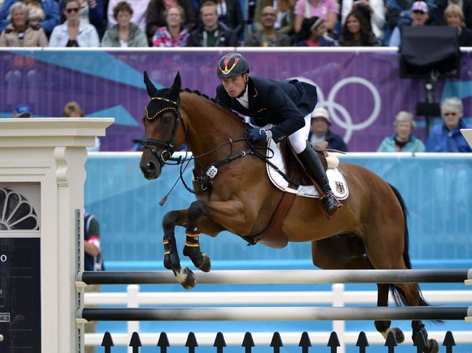 epa03329199 Michael Jung of Germany rides his horse 'Sam' during the Jumping event of the Equestrian Eventing for the London 2012 Olympic Games in Greenwich Park, south of London, Britain, 31 July 2012. Germany took the gold medal at the Team Eventing, Great Britain the silver and New Zealand the bronze. EPA/FRANCK ROBICHON