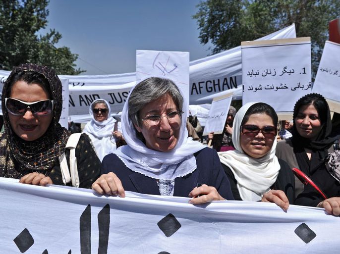 Kabul, -, AFGHANISTAN : Afghanistan head of Human Rights Commision Seema Samar (C) marches with Afghan women to protest the recent public execution of a young woman for alleged adultery, in Kabul on July 11, 2012. Dozens of Afghan women's rights activists took to the streets July 11 to protest the recent public execution of a young woman for alleged adultery, which was captured in a horrific video. AFP PHOTO/Massoud HOSSAINI