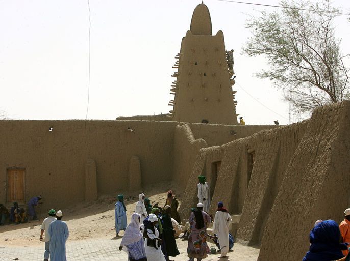 A picture taken on April 10, 2006 shows local residents walking near a mosque in Timbuktu. Al-Qaeda linked Islamists in northern Mali went on the rampage in Timbuktu on June 30, 2012