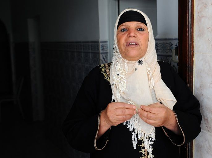 A file picture taken on November 15, 2011 shows the mother of Mohamed Bouazizi, the fruit-seller whose self-immolation sparked the revolution that ousted a dictator in Tunisia and ignited the Arab Spring, Manoubia Bouazizi, standing at the door of her home in Tunis. The mother of Mohamed Bouazizi, the street vendor whose self-immolation sparked Tunisia's revolution, was given a suspended four-month jail term on July 20, 2012