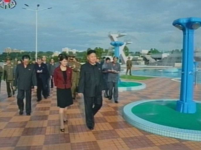 A still image, taken from the (North) Korean Central TV Broadcasting station 25 July 2012 shows North Korean leader Kim Jong-un, accompanied by a woman recently confirmed to be his wife, during a visit to the Rungra People's Amusement Park in Pyongyang. The woman, identified only by hersurname Hong, has made several public appearances with the leader since July 5th when she was seen seated to the right of the leader during a music