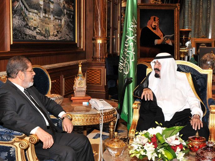 A handout photograph made available by the Egyptian Presidency on 12 July 2012, shows Egypt's President Mohamed Morsi (L) and Saudi Arabia's King Abdullah bin Abdul Aziz (R) during their meeting in Jeddah, Saudi Arabia, late 11 July 2012.