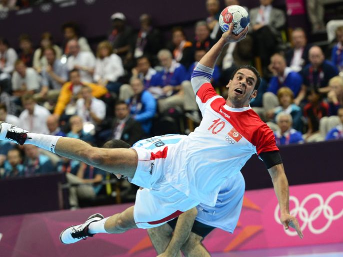 Tunisia's centreback Kamel Alouini jumps to shoot during the men's preliminary Group A handball match Argentina vs Tunisia for the London 2012 Olympics Games on August 6, 2012 at the Copper Box hall in London. AFP PHOTO/ JAVIER SORIANO