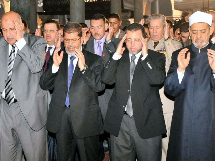 A Handout photograph released by the Egyptian Presidency shows Egyptian President Mohamed Morsi (2-L), Vice President Mahmoud Mekki (L), Prime Minister Hisham Qandil (2-R), Sheikh of Al-Azhar Ahmed al-Tayeb Al-Jalaa (R), performing the Eid al-fitr prayer, at the Amr ibn al-As mosque, in Cairo, egypt, 19 August 2012. Eid-al Fitr marks the end of the fasting month of Ramadan. EPA/EGYPTIAN PRESIDENCY/HANDOUT HANDOUT EDITORIAL USE ONLY/NO SALES