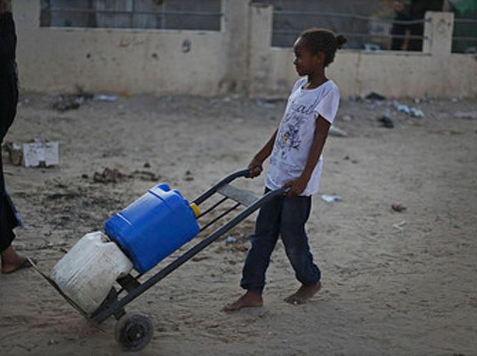 A Palestinian refugee transports water containers after filling them with water from a UN water station in Al-Shabora refugee camp in Rafah City on 11 August 2012. Reports state that the Shabora camp residents suffer from a lack of drinking water in homes, people turn to fill water from the water desalination plant to provide homes with water, which is from the International support for Gazans, and it's free for citizens. EPA/ALI ALI