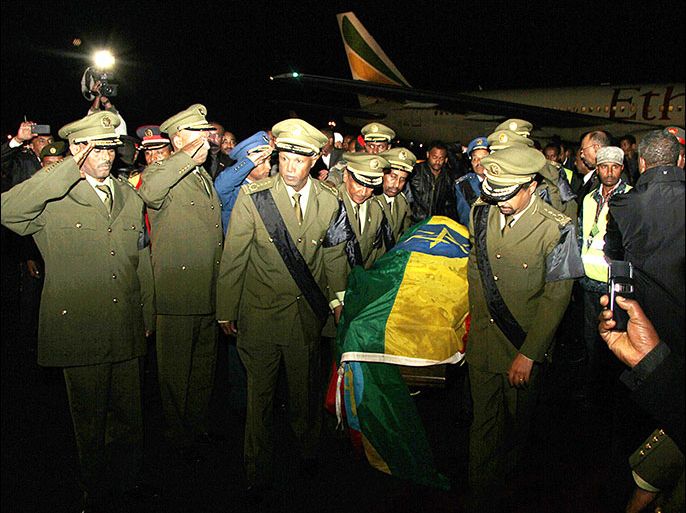 afp : Military officers carry of the coffin of Meles Zenawi at Bole International International Airport in Addis Ababa on August 21, 2012. Meles died in hospital in Brussels late Monday after he caught an infection following a long bout of illness. Thousands of people, including government officials, diplomats and religious leaders gathered around the airport the greet the deceased leader and many mourners wailed with grief. Meles' wife Azeb Mesfin, dressed in black, was seen leaving the plane and wailed as she walked ahead of her husbands body in a hearse. AFP PHOTO/MULUGETA AYENE