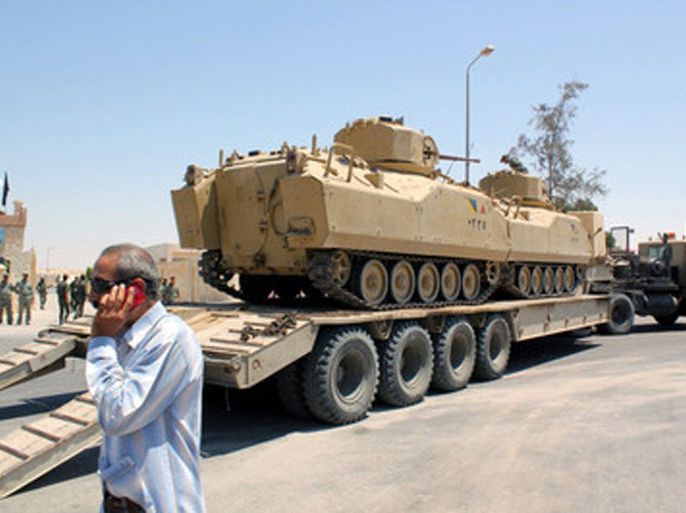 Egyptian army tanks loaded on trucks are seen ahead of expected offensive against militants, in Arish, northern Sinai, 09 August 2012. Media reports state that Egypt on 09 August sent reinforcements to the Sinai Peninsula as it pursues a military campaign against Muslim militants suspected of killing 16 of its soldiers. Troops have been positioned in Al-Arish, the capital of the North Sinai province, ahead of renewed raids on militant strongholds, according to witnesses.