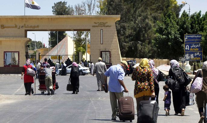 EGYPT : Travellers walk with their belongings towards the Egyptian side of the Rafah border crossing on August 10, 2012. Egypt temporarily reopened the Rafah border crossing into the Gaza Strip, which was closed after militants attacked troops on August 18