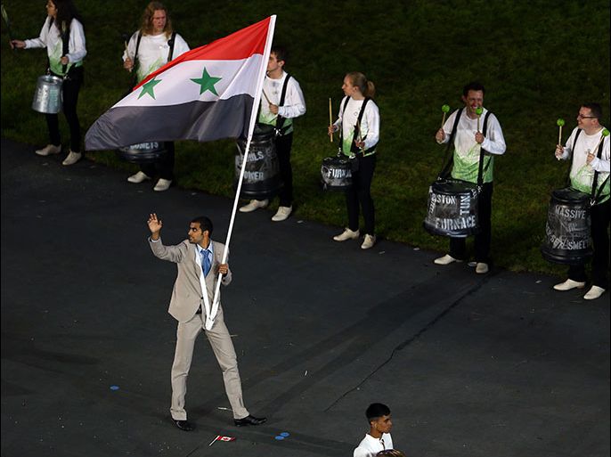 LONDON, ENGLAND - JULY 27: Majed Aldin Ghazal of the Syria Olympic athletics team carries his country's flag during the Opening Ceremony of the London 2012 Olympic Games at the Olympic Stadium on July 27, 2012 in London, England. (Photo by Paul Gilham/Getty Images)