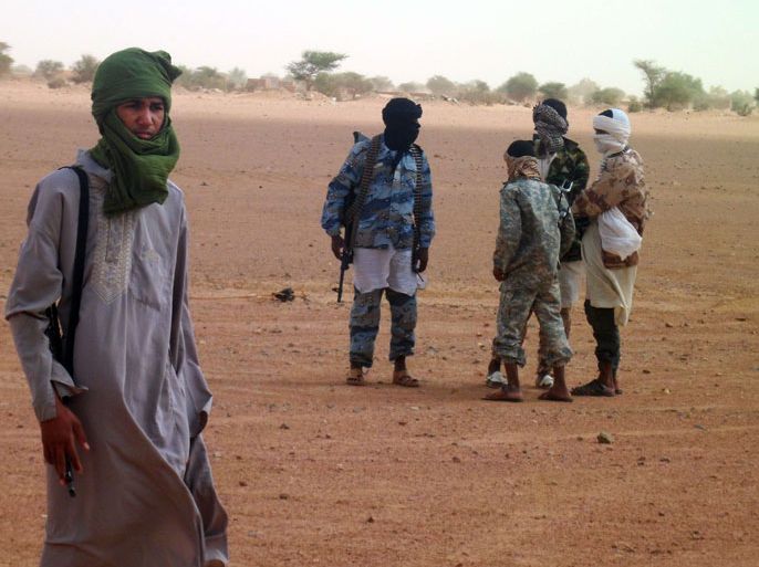 KIDAL, -, MALI : Photo taken on August 7, 2012 shows fighters of the Islamic group Ansar Dine standing in Kidal in northern Mali. Mali's government said on August 9 that military intervention