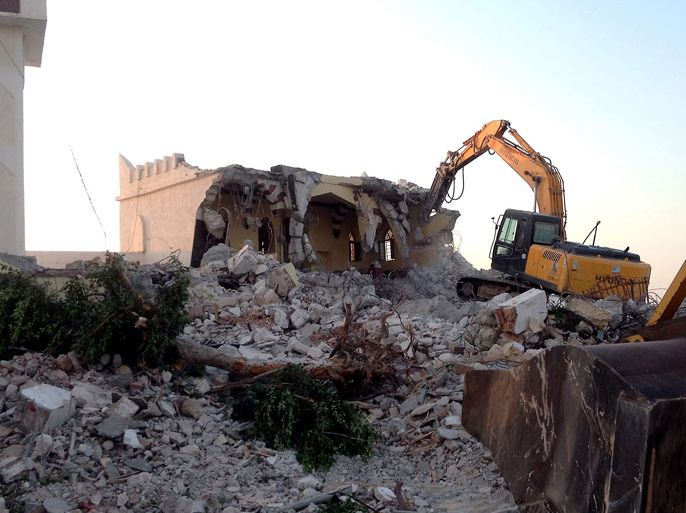 Libyan Islamist hardliners use a bulldozer to raze the mausoleum of Al-Shaab Al-Dahman near the centre of Tripoli on August 25, 2012. Islamist hardliners bulldozed part of the revered mausoleum in Tripoli in the second such attack in Libya in two days, an AFP correspondent reported. AFP PHOTO/MAHMUD TURKIA