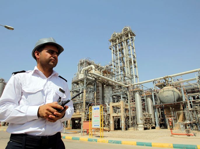 (FILE) A file photograph showing an Iranian security guard walking in front of the Mahshahr petrochemical complex in Khuzestan province south western Iran, 28 September 2011. Media reports state on 11 April 2012 that Iran has extended a ban on oil exports to Germany and Italy and plans to ban imports from European Union countries. A ban has already been imposed on Britain, France, Greece, and Spain. The Oil Ministry has so far only confirmed the ban on Greece. EPA/ABEDIN TAHERKENAREH