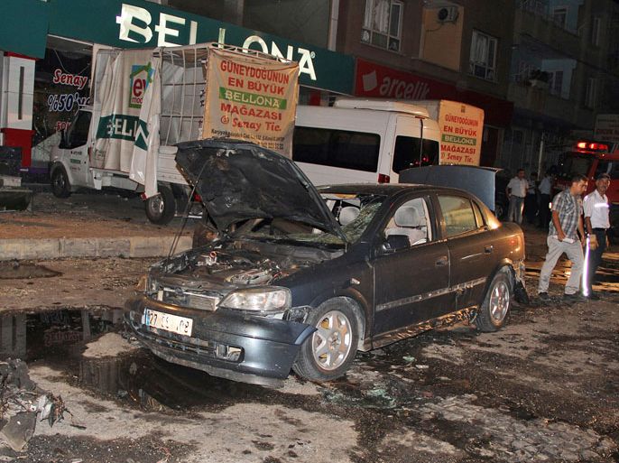 Damaged vehicles are seen after a bomb explosion near the Karsikaya district Police station in Gaziantep, near the border to Syria, in Turkey, 21 August 2012. A bomb apparently concealed inside a car went off killing at least eight people and wounding many others. No group has so far claimed responsibility, but Kurdish militants are know to be active in the area. EPA/STRINGER TURKEY OUT