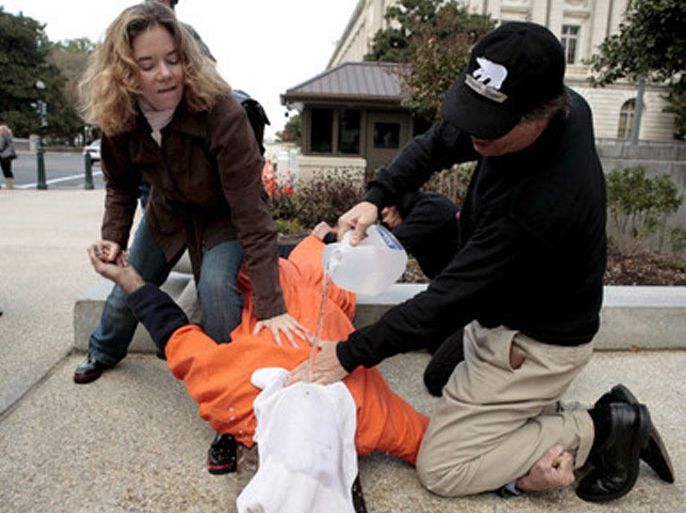 Human rights activists demonstrate waterboarding on a volunteer outside the Dirksen Senate office building on Capitol Hill in Washington DC USA on 06 November 2007. The Senate Judiciary Committee will vote today on the nomination of Michael Mukasey, President Geroge W. Bush's nominee for Attorney General. Mukasey refuses to say whether waterbaording, which simulates drowning, is or is not torture. EPA/MATTHEW CAVANAUGH