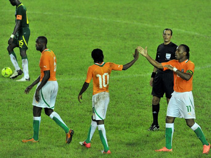 Ivory Coast national football team's players Didier Drogba (R), Gervais Yao Kouassi aka Gervinho (C) and Yaya Toure celebrates their team's goal during the African Cup of Nations qualification match between Ivory Coast and Senegal at the Felix Houphouet-Boigny stadium in Abidjan on September 8, 2012. AFP PHOTO / ISSOUF SANOGO