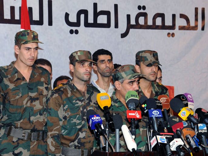 A group of the Free Syrian Army (FSA) attend an opposition conference in Damascus, Syria, 26 September 2012. According to media sources, a group of soldiers and officers from the FSA showed up at an opposition groups conference in Damascus and announced laying down their arms and joining reconciliation efforts in Syria. Representatives from 28 opposition groups met in Damascus to discuss means of finding a peaceful solution to the Syrian crisis and launching a national dialogue among different factions.