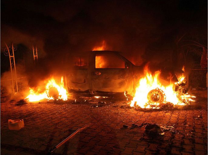 A vehicle and the surrounding area are engulfed in flames after it was set on fire inside the US consulate compound in Benghazi late on September 11, 2012. An armed mob protesting over a film they said offended Islam, attacked the US consulate in Benghazi and set fire to the building, killing one American, witnesses and officials said. AFP PHOTO
