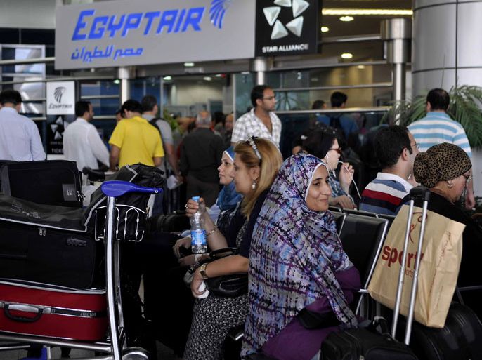 Egyptian passengers sit at a terminal at the airport in Cairo on September 7, 2012 as Egypt's national airline Egyptair said it had suspended international flights for 12 hours because of a strike by air hostesses and stewards. AFP PHOTO/STR