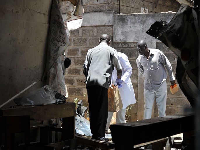 Investigators inspect the site where a blast ripped through a church in Nairobi on September 30, 2012. A suspected grenade attack killed one child and wounded nine others in a Nairobi church today, a day after Islamist fighters