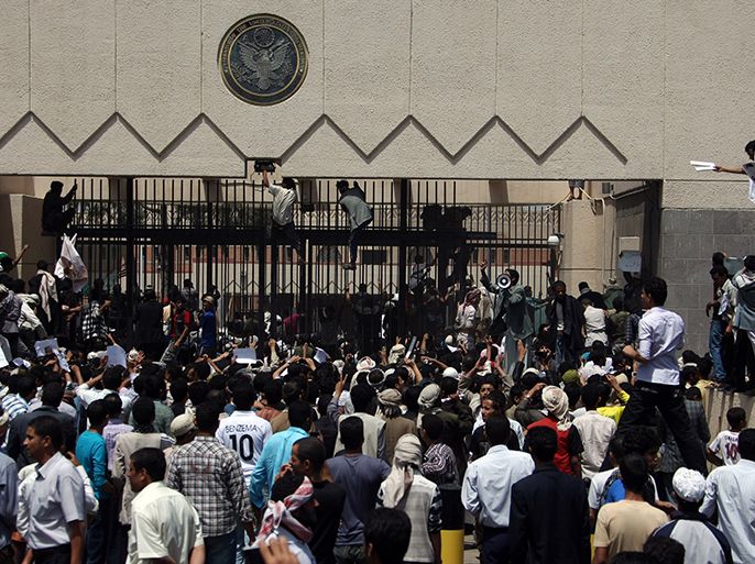 Yemeni protesters try to break though the gate of the US embassy in Sanaa during a protest over a film mocking Islam on September 13, 2012. Yemeni forces managed to drive out angry protesters who stormed the embassy in the Yemeni capita with police firing warning shots to disperse thousands of people as they approached the main gate of the mission. AFP