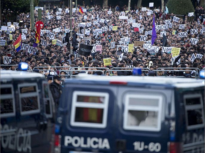 Police vans block a street leading to the parliament building in Madrid on September 29, 2012 during a demonstration organized by Spain's "indignant" protesters, a popular movement against a political system that they say deprives ordinary Spaniards of a voice in the crisis. Helmeted riot police fired rubber bullets and baton-charged protesters on September 25, 2012 as thousands rallied near parliament in anger at the economic crisis, in clashes that left at least 14 people wounded. AFP PHOTO / DANI POZO