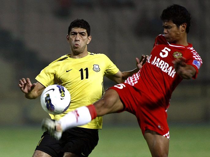 Arbil's midfielder Loai Salah (L) challenges Kelantan's defender Nik Mohd during their AFC Cup quarter-final football match at Francois Hariri Stadium in the northern Iraqi city of Arbil on September 18, 2012. Arbil won 5-1