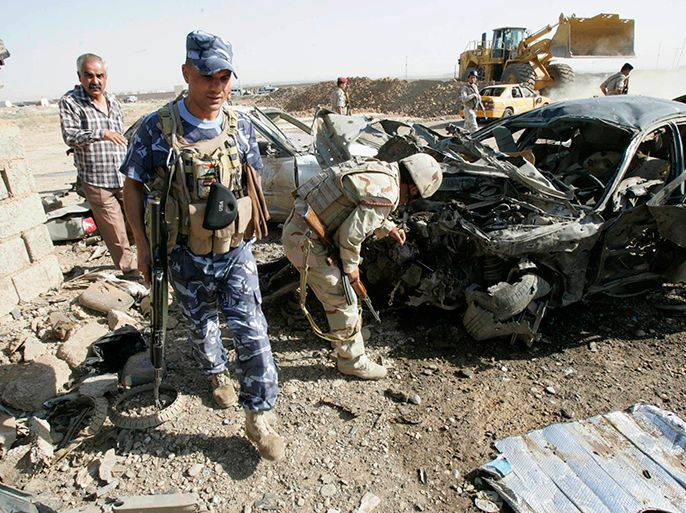Security personnel inspect the site of a bomb attack in Kirkuk, 250 km (155 miles) north of Baghdad, September 9, 2012. A suicide bomber killed at least five people at a police recruitment centre in the oil-rich city of Kirkuk, according to local police. REUTERS