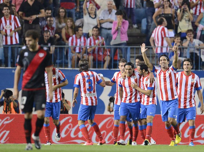 Atletico Madrid's players celebrate after Turquish Arda Turan scored during the Spanish league football match Atletico Madrid vs Rayo Vallecano at the Vicente Calderon stadium in Madrid on September 16, 2012