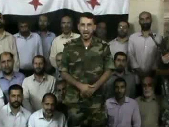 An image grab taken from a video uploaded on YouTube on October 4, 2012 and released by Al-Baraa Brigade shows an unidentified Syrian rebel standing in front of 30 hostages who the brigade said are Iranian prisoners at an unidentified location in Syria. The rebel said one Iranian prisoner will "be executed for every martyr that falls" once the rebels' ultimatum to release them in return of prisoners held by the Syrian regime expires. AFP PHOTO/YOUTUBE
