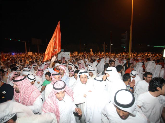 Kuwaiti opposition supporters gather during a protest in Kuwait City, on October 21, 2012, against the decision by Emir Sheikh Sabah al-Ahmad al-Sabah to amend the electoral law despite it having been confirmed by a court last month. Kuwaiti riot police beat opposition protesters who were gathering for a massive demonstration against a decision to change the electoral law, organisers and witnesses said. AFP PHOTO/YASSER AL-ZAYYAT