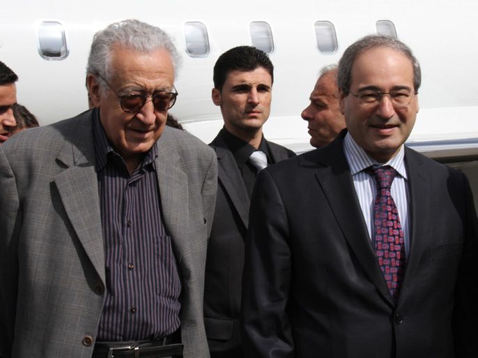 epa03438750 The UN-Arab League special envoy to Syria, Lakhadar Brahimi (L), walks with Deputy Syrian Foreign Minister, Faisal Mekdad (R), upon arrival at the Damascus international airport in Damascus, Syria, 19 October 2012. Media reports state that Brahimi arrived in the Syrian capital Damascus for talks on a truce during a Muslim holiday later this month. EPA/STR