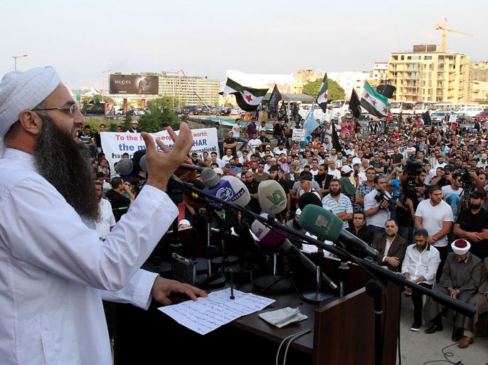 Lebanese radical Sunni Sheikh Ahmad al-Assir addresses supporters during a protest against the Syrian regime in the Lebanese capital Beirut on October 14, 2012. Many hundreds of people took to the streets of Beirut in two separate demonstrations, with some demanding the fall of neighbouring Syria's regime of President Bashar al-Assad, and others expressing support for Damascus. AFP PHOTO / ANWAR AMRO